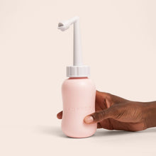 Load image into Gallery viewer, Woman's hand holds the peri bottle upright
