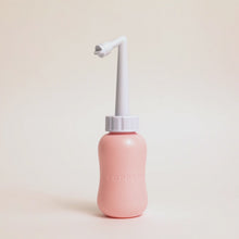 Load and play video in Gallery viewer, Video of a woman's hands holding the peri bottle and demonstrating how the nozzle is adjustable in length.
